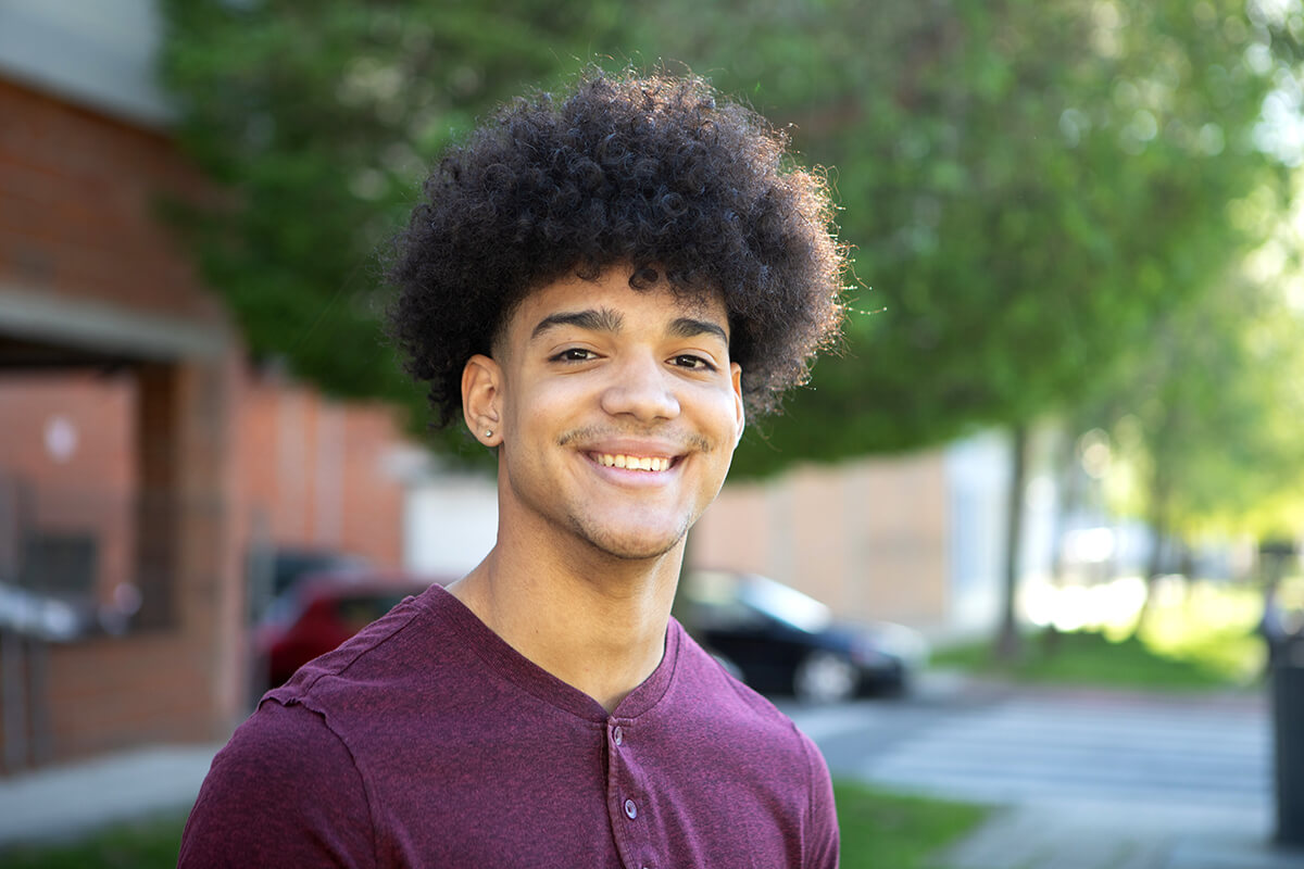 male teen smiles outside a north carolina teen counseling center