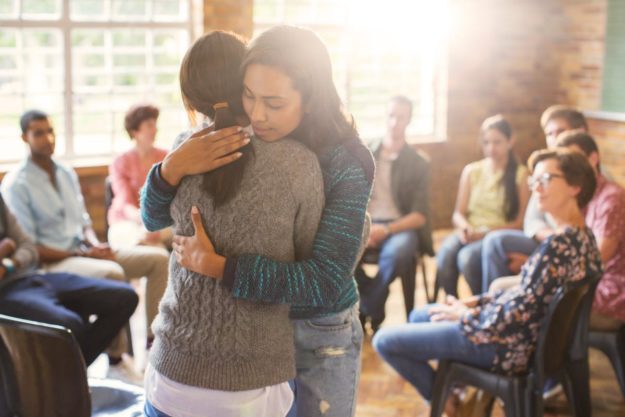 5 Reasons to Go to Group Counseling two women hugging in group counseling
